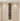 Wooden wine cabinet with embedded wine rack on a light wooden floor.