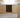 Wooden kitchen cabinet with built-in wine rack containing bottles.