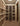 Wine cellar with wooden shelves filled with wine bottles.