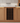 Wooden wine rack embedded in a kitchen cabinet with bottles inside.
