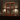 Wooden shelf with various bottles on a bar setting