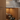 Wooden kitchen cabinet with a pull-out wine rack containing bottles.
