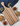 Wooden serving board with striped pattern on a white surface with snacks.