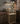 Wooden wine rack with bottles and glasses in a kitchen setting.