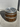 Wooden barrel with metal bands and cap on a concrete surface