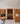 Wine cellar with wooden shelves and a reception desk.