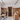Wine cellar with wooden shelves and people interacting, modern interior design.