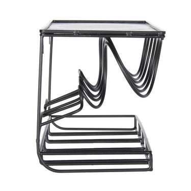 Modern black metal side table with a glass top on a white background