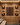 Wooden wine cellar with neatly arranged wine bottles in a grid pattern.