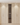Wooden wine cabinet with embedded wine rack on a light wooden floor.