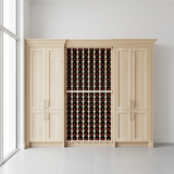 Wooden wine cabinet with wine bottles inside, in a bright room with large windows.