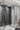 Modern wine cellar with glass doors in a room with a piano
