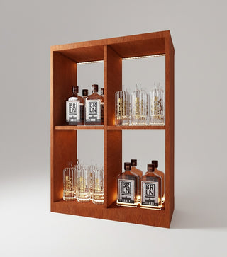 Wooden shelf with illuminated bottles and glasses on a gray background