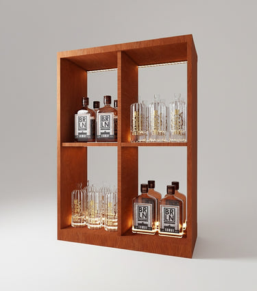 Wooden shelf with illuminated bottles and glasses on a gray background