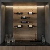 Wine bottles on a wooden wall in a modern kitchen setting