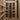 Wine cellar with wooden shelves filled with wine bottles.