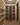 Wine cellar with wooden shelves filled with wine bottles.