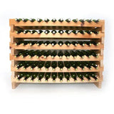 Wooden wine rack with multiple bottles of wine on a white background