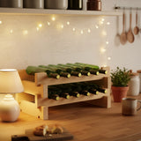 Wooden wine rack with bottles on a kitchen counter with string lights and kitchen utensils.