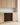 Wooden wine rack embedded in a kitchen cabinet with light wood finish.