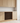 Wooden wine rack embedded in a kitchen cabinet with light wood finish.