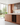 Modern kitchen with wooden cabinets, wine rack, and large windows.