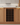 Wooden wine rack embedded in a kitchen cabinet with bottles inside.