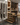 Modern wine cellar with wine bottles on racks and wooden shelves.