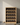 Wooden wine rack with bottles against a neutral wall
