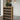 Wooden wine rack with bottles in a modern interior setting.