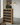 Wooden wine rack with bottles in a modern interior setting.