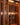 Wine cellar with wooden shelves filled with wine bottles.