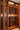 Wine cellar with wooden shelves filled with wine bottles.
