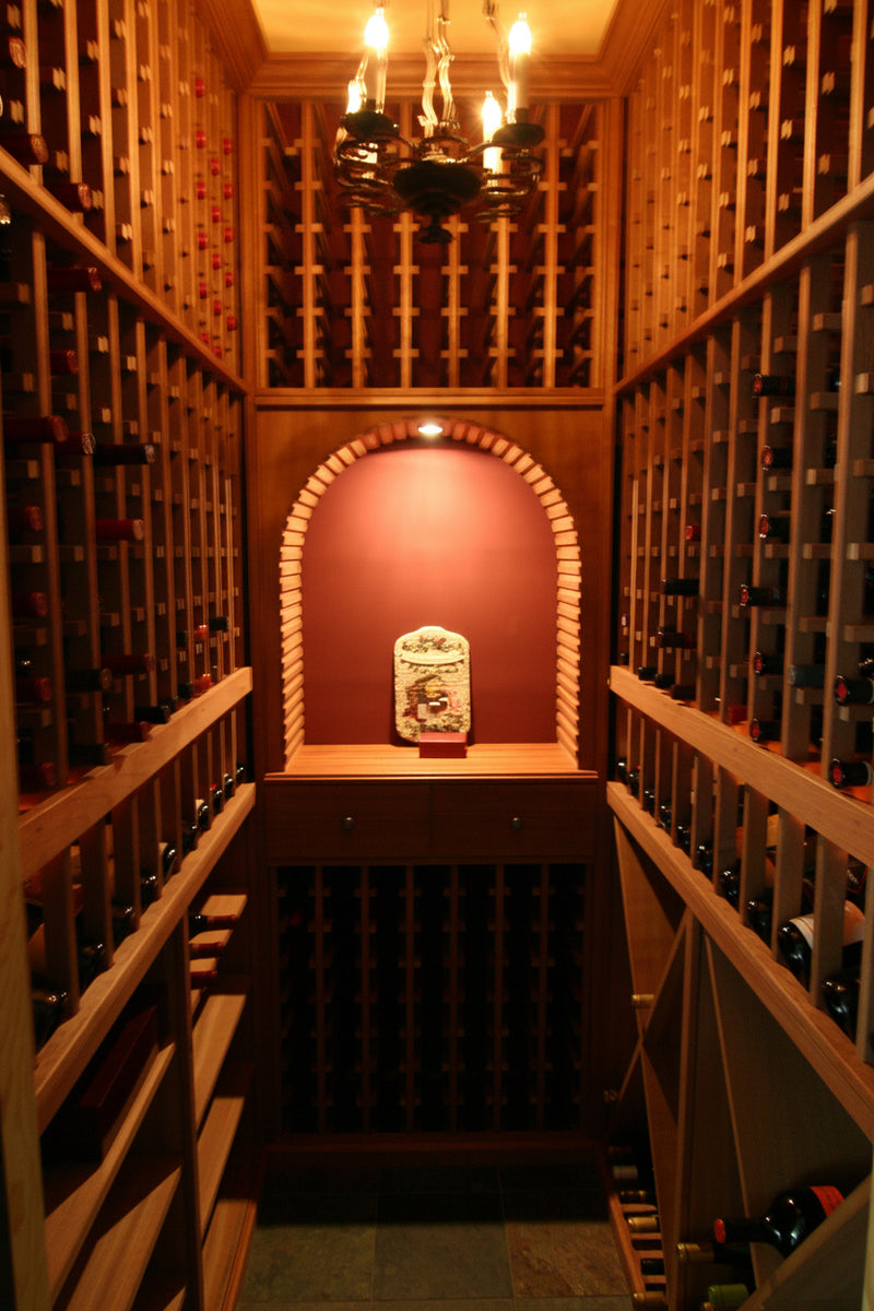 Wine cellar with wooden shelves and a chandelier
