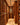 Wine cellar with wooden shelves filled with wine bottles.