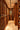 Wine cellar with wooden shelves filled with wine bottles.