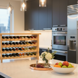 Modern kitchen with wine rack, fruit bowl, and stainless steel appliances.