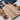 Wooden cutting board with various snacks on a marble surface