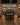 Wine store with wooden shelves and a wine rack displaying various bottles.