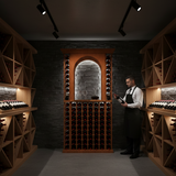 Man in a wine cellar holding a bottle of wine