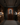 Man in a wine cellar holding a bottle of wine