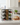 Wine rack with bottles on a kitchen counter with bread and coffee.