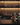 Wine rack with bottles on a bar counter with a blurred bar background