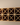 Wooden wine rack with bottles against a plain wall