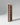Wooden wine rack with red wine bottles on a gray background