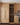 Wooden kitchen with built-in wine rack and stainless steel appliances.