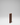 Wooden wine rack with multiple bottles on a gray background