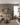 Modern living room with beige sectional sofa, coffee table, and decorative elements.