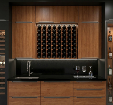 Modern kitchen with wooden cabinets, wine rack, and black countertop.