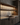 Modern kitchen with wooden cabinets, a sink, and glass shelves.